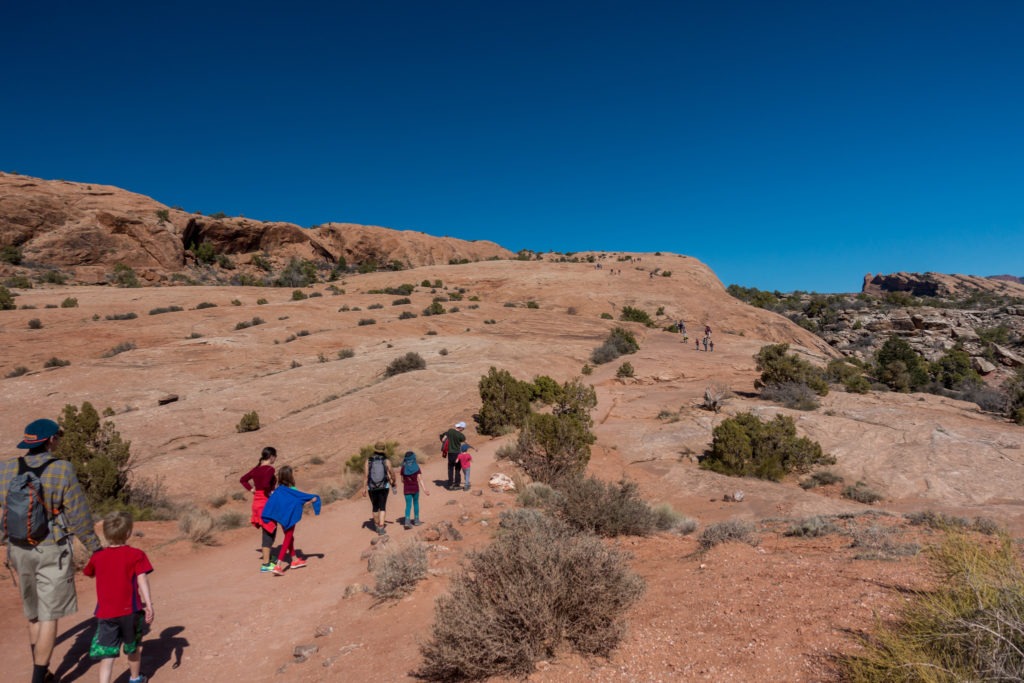 Arches: Ascending Sandstone Slope to Delicate Arch